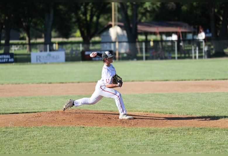 Hartman throws a pitch from the pitcher's mound during a game.