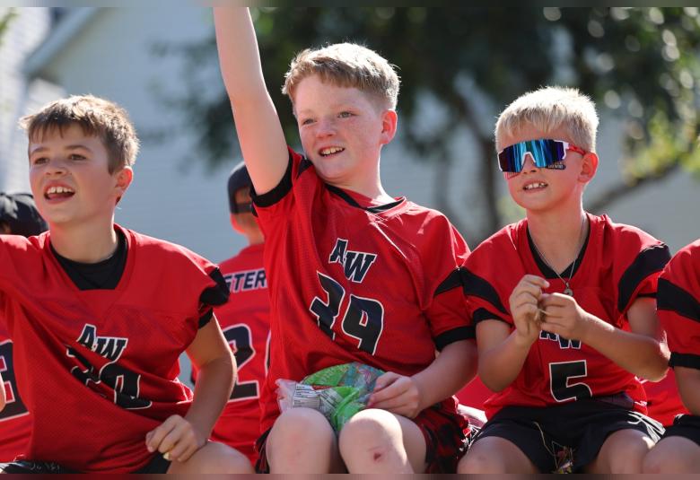 A-W youth football players ride along on a float during Friday’s homecoming parade. Pictured are Case Harris, William Kluender, and Landon Jacobs.