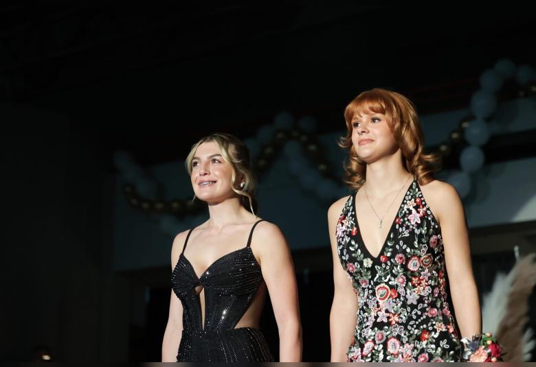 Isabella Utesch and JosiLynne Lennon walk in the Grand March festivities.