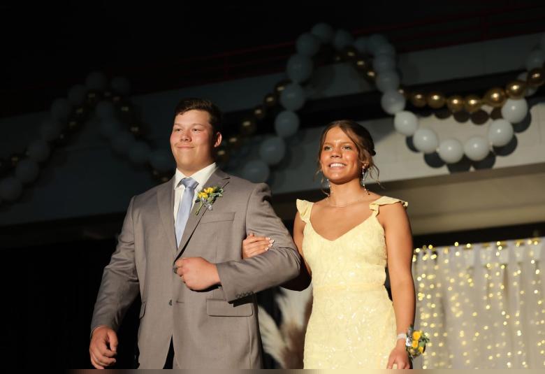 Matthew Swancutt walks Destiny Hansen down the Grand March.