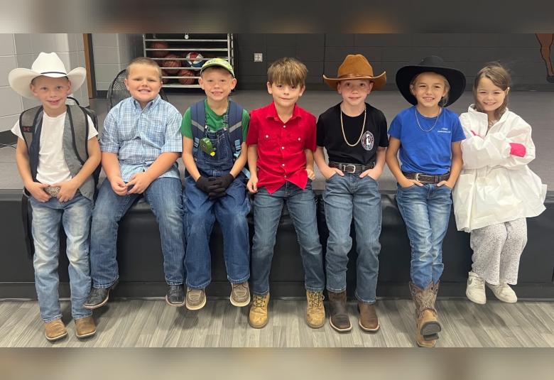 Pictured from left, Marcus Calvert, Case Schoenfelder, Daxton Hoffman, Soren Hoffman, Charlie Hughes, Remi Sievert, and Jazmyn Williams, don their future career attire as part of The Game of Life Day. (Photo courtesy of A-W School)