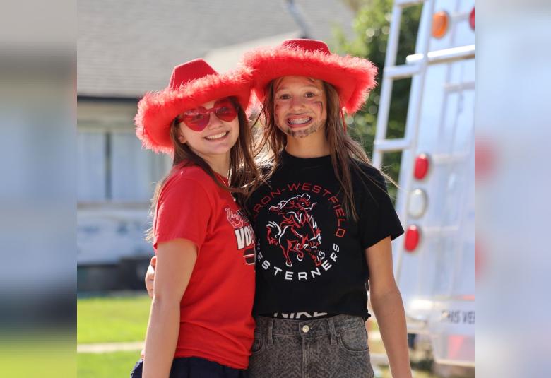 Bentli DeRocher and Haidynn DeRocher show their school spirit as part of the homecoming parade festivities on Friday.