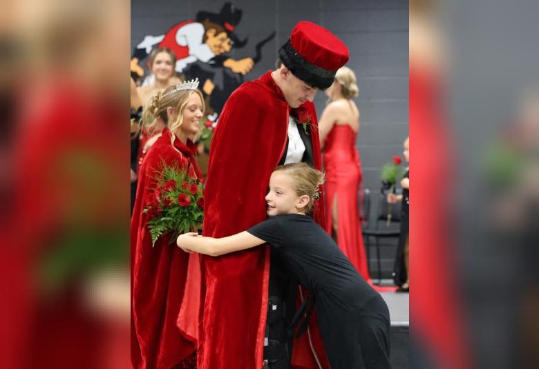 Homecoming King Reegan McKee gets a big hug  from his sister, Jessa McKee following the coronation.
