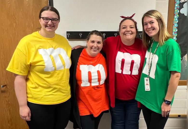 A-W elementary teachers, Elizabeth Robbins, Taylor Kjose, Jennifer Small, and Autumn Wren, dressed up as M&Ms during homecoming week. (Photo courtesy of A-W School)