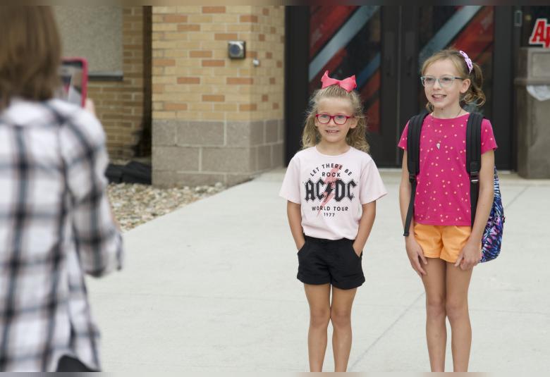 Members of the Akron Legion Post 186, as well as A-W students line the sidewalk and welcome students back for the first day.