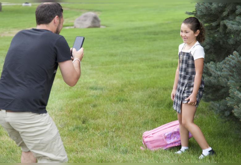 Justin Rhein makes sure to snap a quick photo of his daughter, Lucy Larson, before the start of the new school year.