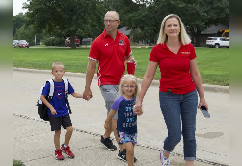 Adam and Rachelle, and MJ Loutsch, walk Alex into the school for his first day. MJ will start preschool next week.