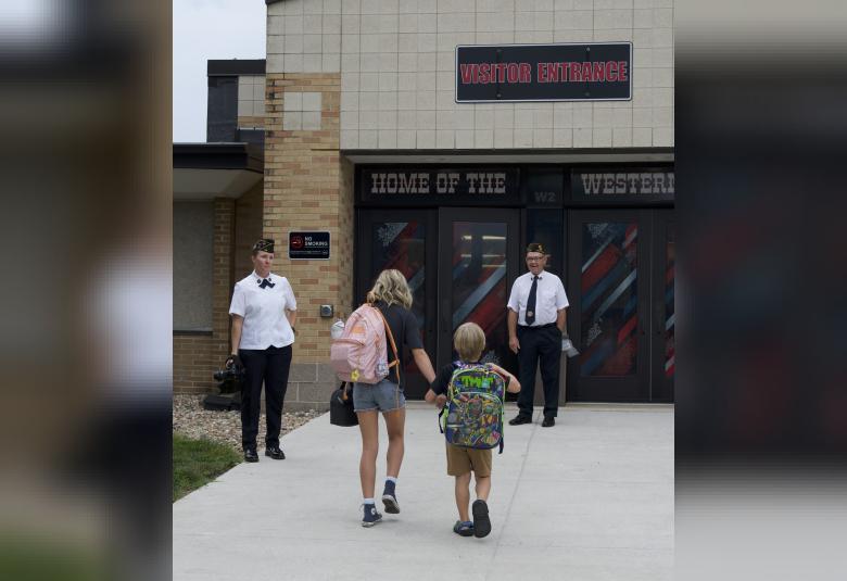 Akron Legion Post 186 members Kaylene Hawkins and Garry Jacobson greet students on their first day back at Akron-Westfield.